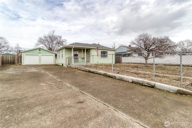 bungalow featuring an outdoor structure, a detached garage, and fence