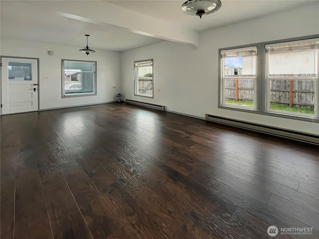 spare room with a baseboard heating unit, dark wood-type flooring, beamed ceiling, and baseboards