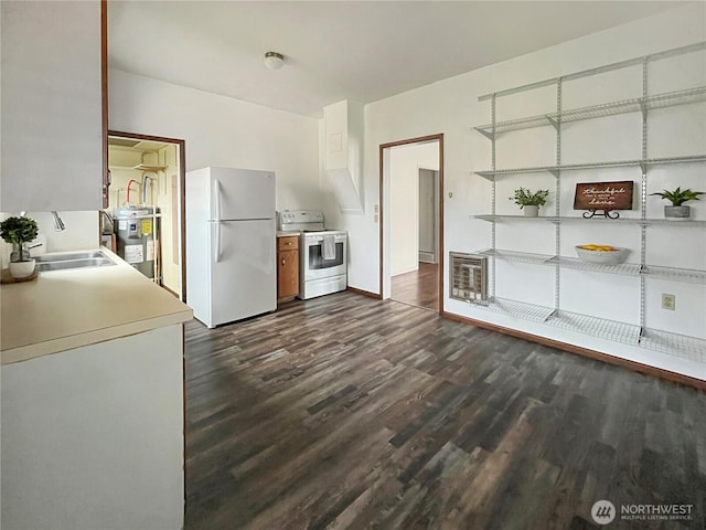 kitchen with white appliances, a sink, water heater, light countertops, and heating unit