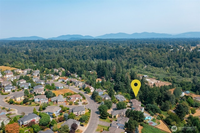 aerial view with a residential view, a mountain view, and a forest view