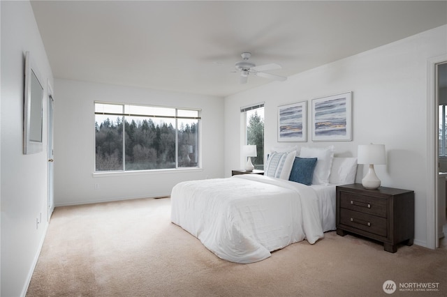 carpeted bedroom featuring a ceiling fan and baseboards