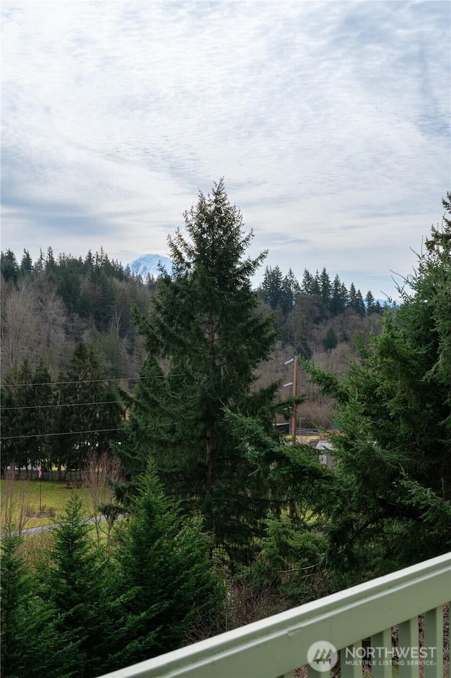 view of landscape featuring a forest view