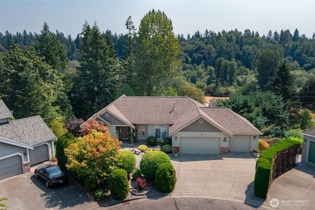 birds eye view of property with a view of trees