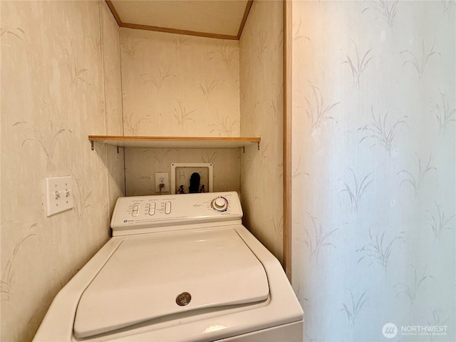 laundry area featuring laundry area, washer / dryer, and ornamental molding