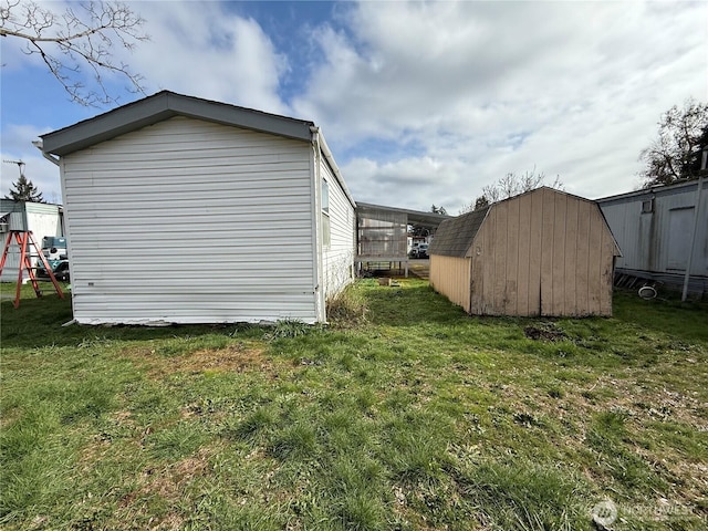 view of side of property featuring a playground, a lawn, an outdoor structure, and a shed