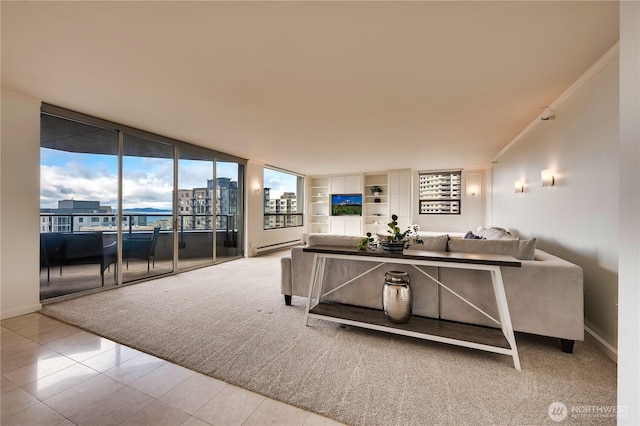 living area featuring a baseboard heating unit, floor to ceiling windows, light carpet, and baseboards