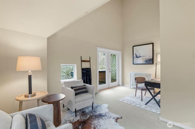 living area featuring high vaulted ceiling, french doors, carpet flooring, and baseboards