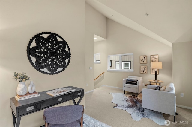 interior space featuring baseboards, high vaulted ceiling, and light colored carpet