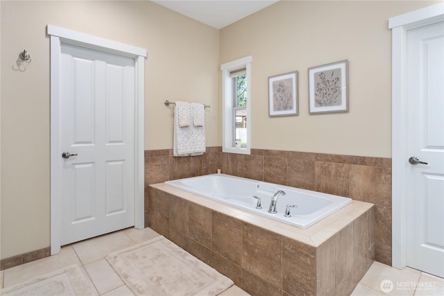 bathroom with a garden tub and tile patterned floors