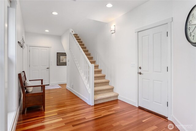 entrance foyer featuring light wood-type flooring, stairs, baseboards, and recessed lighting