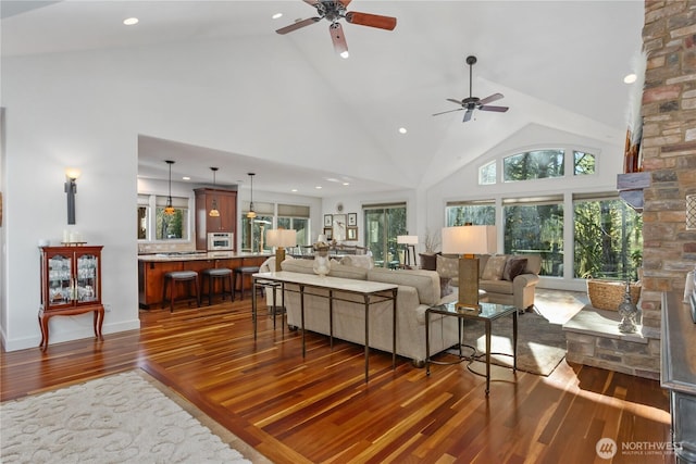 living room featuring a fireplace, recessed lighting, a ceiling fan, wood finished floors, and high vaulted ceiling