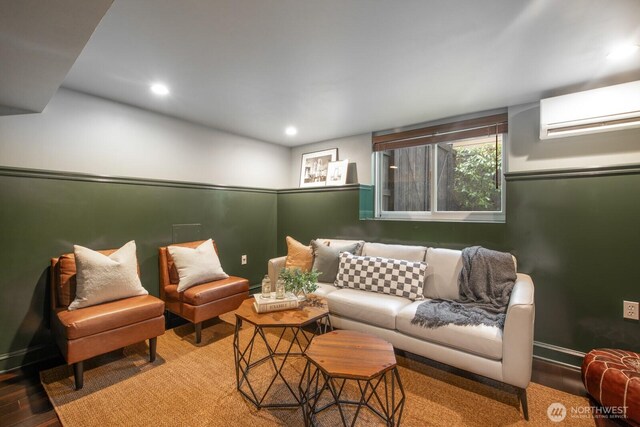 living room with baseboards, an AC wall unit, wood finished floors, and recessed lighting