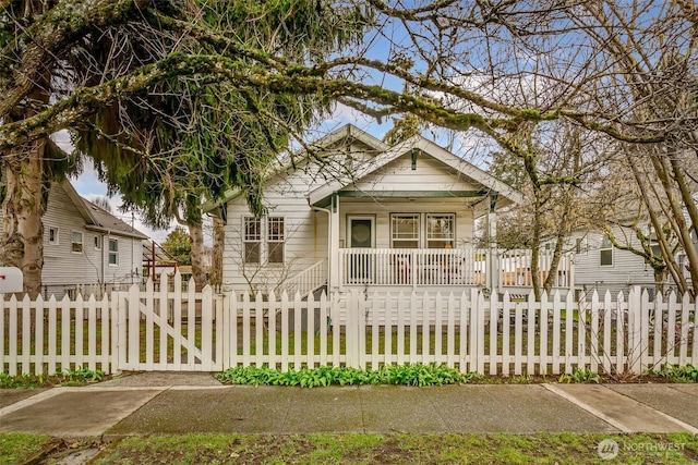 view of front facade with a fenced front yard, covered porch, and a gate