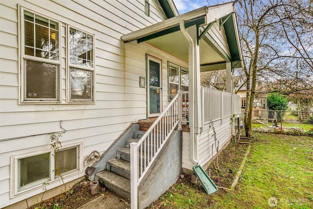 view of exterior entry featuring fence