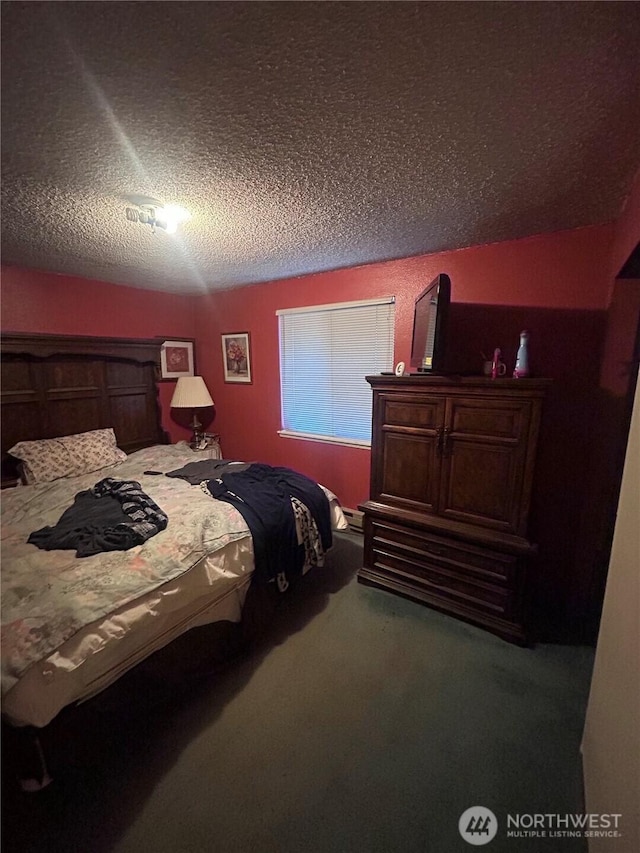 bedroom featuring carpet and a textured ceiling