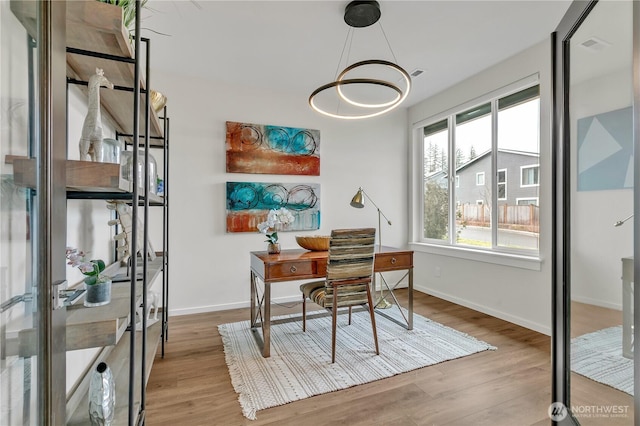 office featuring baseboards and wood finished floors