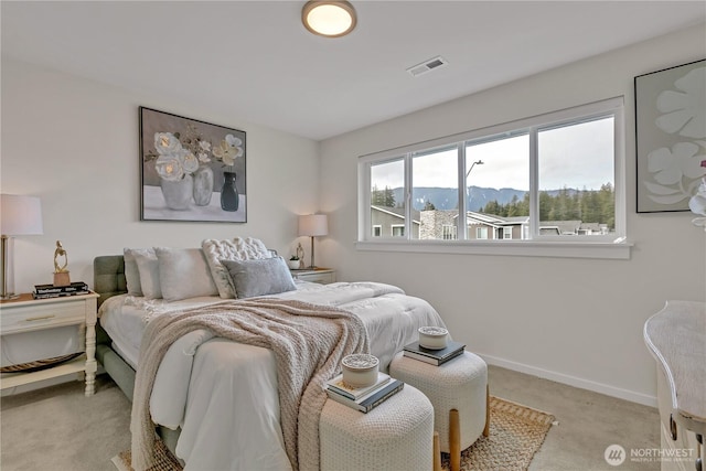 bedroom featuring light carpet, a mountain view, visible vents, and baseboards