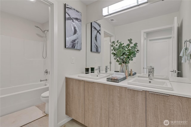 full bathroom featuring shower / washtub combination, a sink, toilet, and double vanity