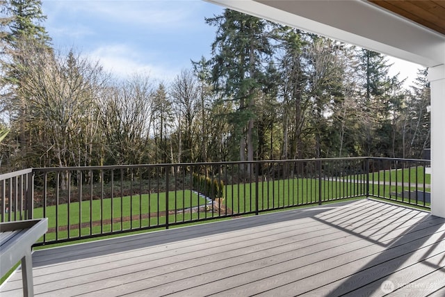 wooden terrace featuring a yard