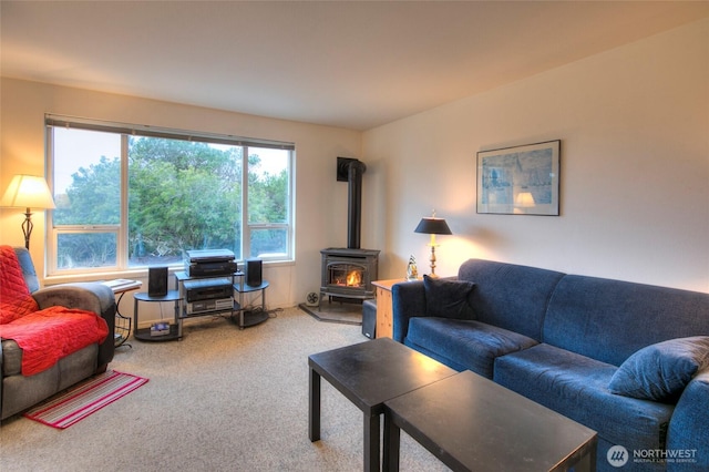 living room with carpet and a wood stove