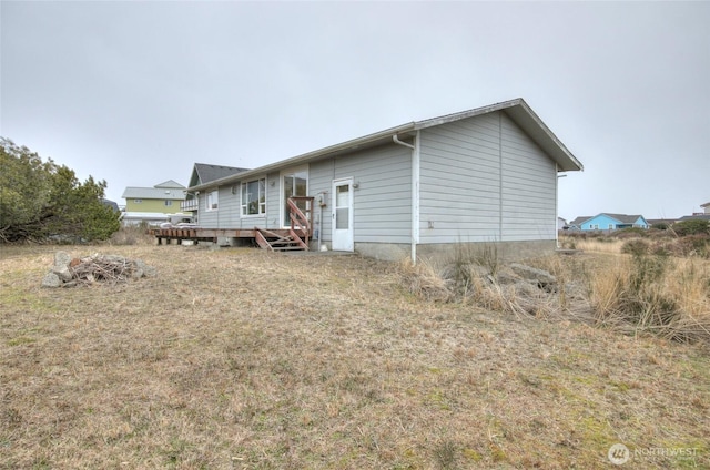 back of house with a deck