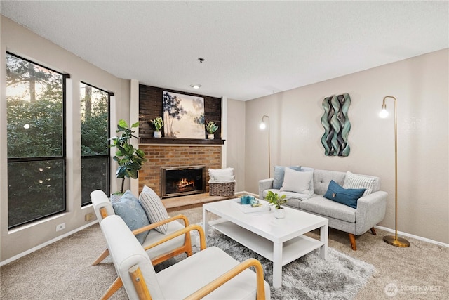 living room featuring a fireplace, carpet flooring, and a textured ceiling