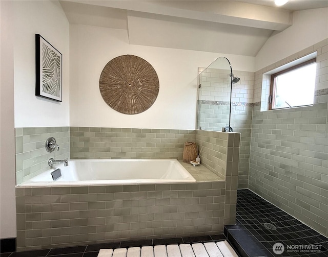 bathroom with vaulted ceiling, tiled shower, and a bath