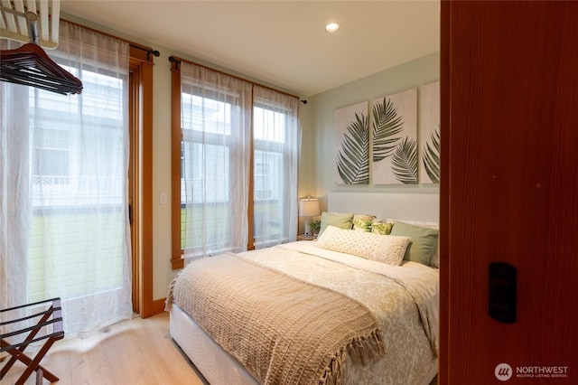 bedroom featuring light wood-style flooring, access to outside, and recessed lighting