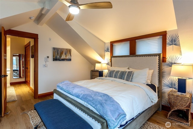 bedroom featuring ceiling fan, vaulted ceiling with beams, baseboards, and wood finished floors