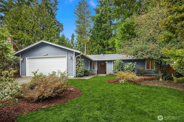 ranch-style home featuring a garage, a front yard, and driveway