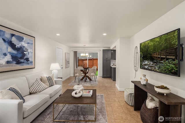 living area featuring recessed lighting, baseboards, a chandelier, and light tile patterned flooring