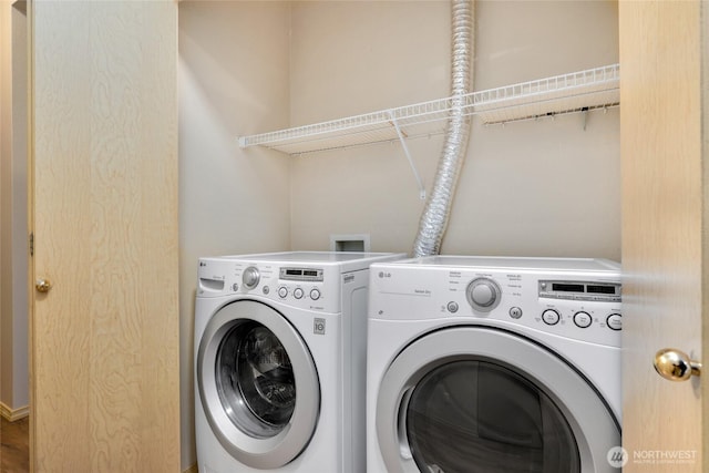 clothes washing area featuring washing machine and clothes dryer and laundry area