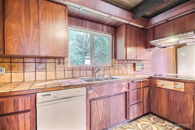 kitchen with tile countertops, a sink, range hood, decorative backsplash, and dishwasher