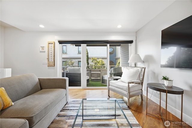 living room featuring recessed lighting, wood finished floors, and baseboards