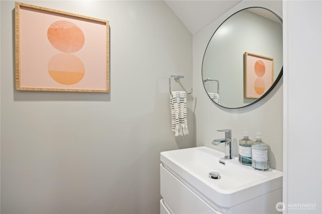 bathroom featuring vaulted ceiling and vanity