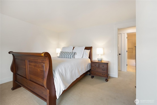 bedroom with baseboards and light colored carpet