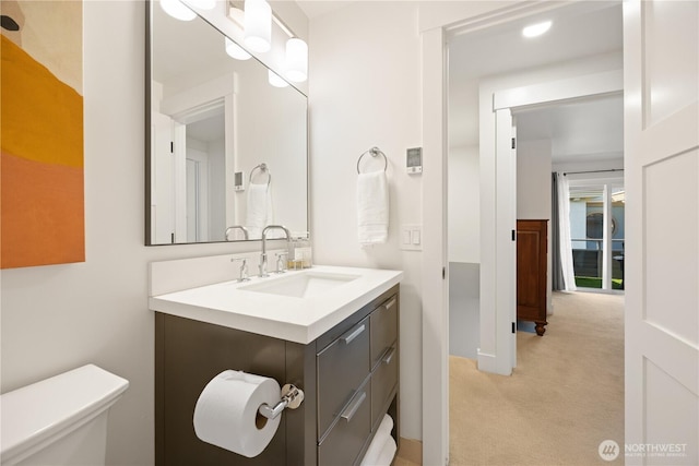 bathroom featuring toilet and vanity