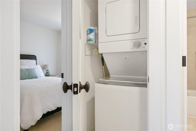 clothes washing area with laundry area and stacked washer / dryer