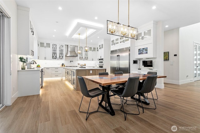 dining room with baseboards, recessed lighting, and light wood-style floors