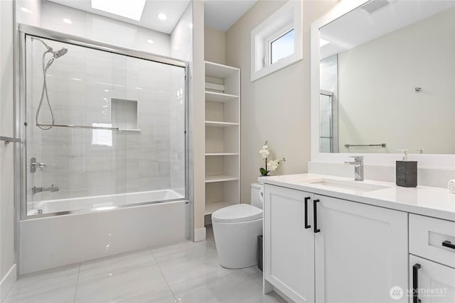 bathroom featuring visible vents, shower / bath combination with glass door, vanity, and toilet