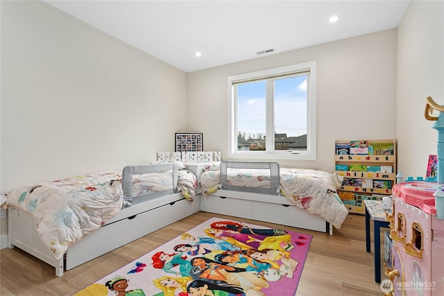 bedroom with light wood-style floors, visible vents, and recessed lighting