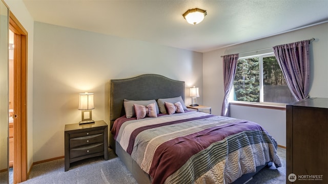 bedroom with carpet and baseboards