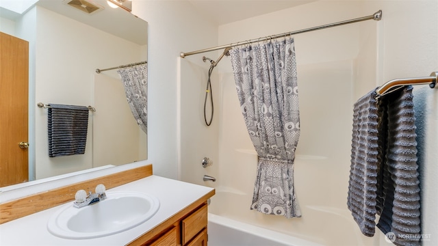 full bath featuring shower / tub combo, visible vents, and vanity