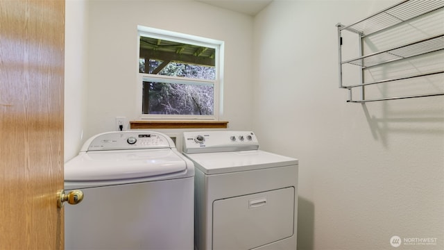 clothes washing area with washing machine and dryer and laundry area