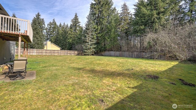 view of yard with fence and a wooden deck