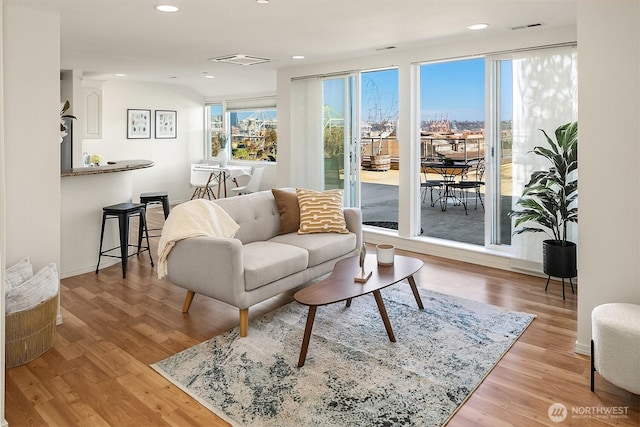 living room featuring visible vents, wood finished floors, and recessed lighting