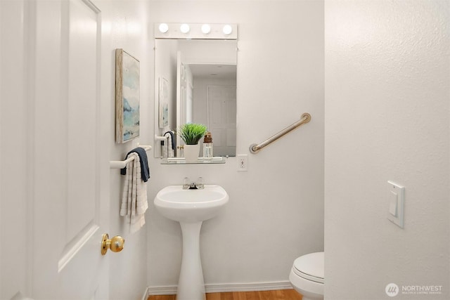 bathroom with wood finished floors and toilet