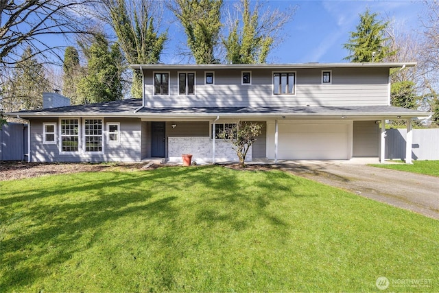 traditional-style home with driveway, a chimney, a front yard, and fence