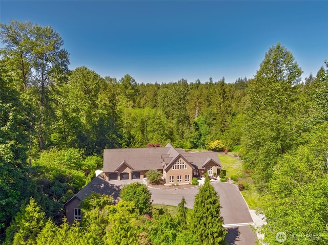 birds eye view of property with a wooded view