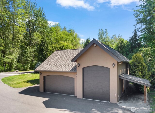 view of front of home with a shingled roof and stucco siding